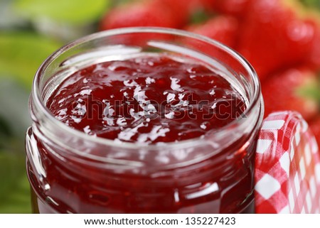 Strawberry jam in a jar, decorated with fresh strawberries