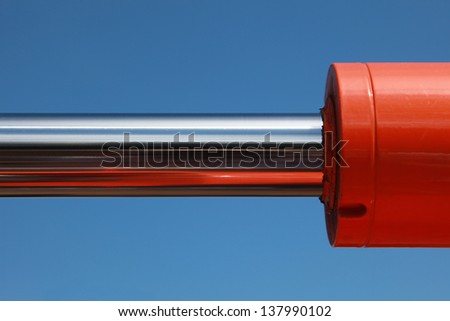 Hydraulic parts of an excavator over blue sky
