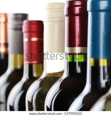 Group of wine bottles in a row isolated on a white background