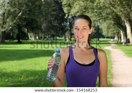 Athletic young woman with a water bottle during sports or running