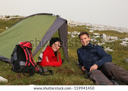 Two young people camping in the mountains alps