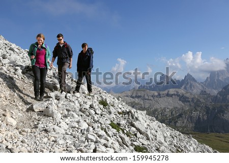 Group of young people hiking in the mountains Alps Dolomites