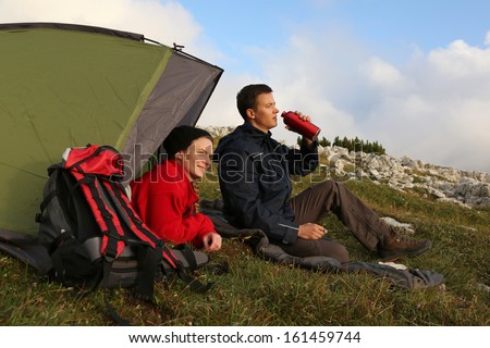 Two young people camping in the mountains