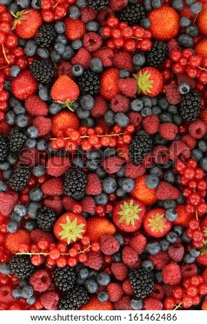 Fresh fruits like strawberries, blueberries, red currants, and blackberries forming a background