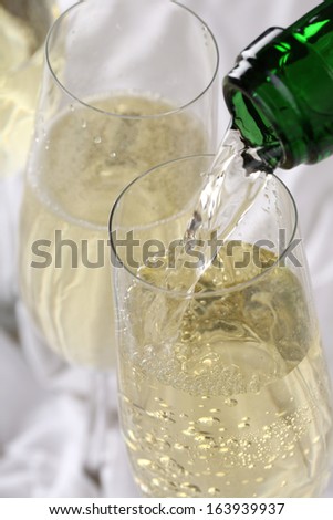 Champagne pouring into a glass on birthday or New Year\'s Eve