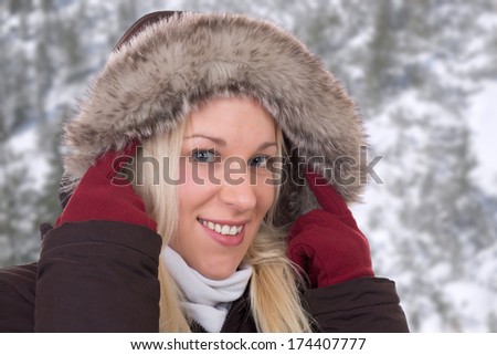 Young woman in winter wearing a fur collar outdoors