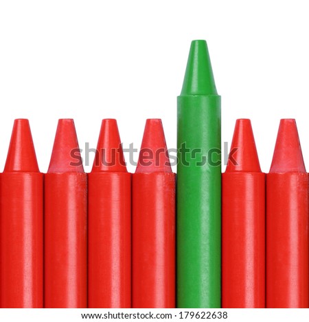 Green crayon standing out from the crowd, success and winning in contest