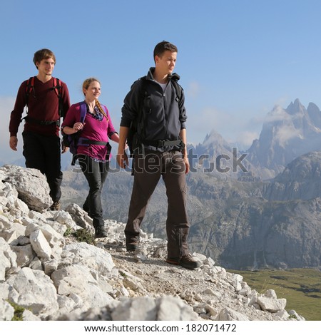 Group of young people hiking in the mountains Alps Italy