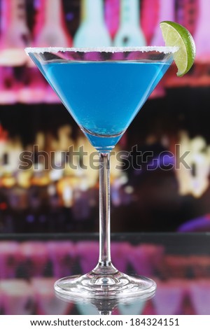 Blue Curacao cocktail in Martini glass in a bar or a party