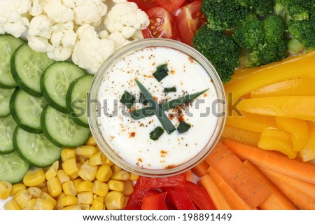 Vegetarian vegetable sticks like paprika, carrots and tomatoes with dip for eating