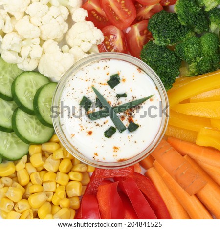 Vegetarian vegetable finger food like paprika, carrots and tomatoes with dip for eating