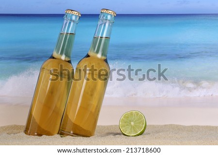 Beer in bottles on the beach and sea while on vacation