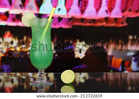 Green fruit juice cocktail drink in a bar or party