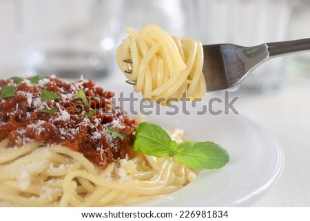 Eating spaghetti Bolognese or Bolognaise noodles pasta meal with fork