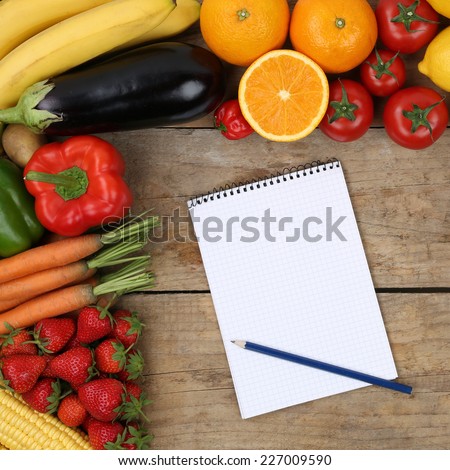 Shopping list with fruits and vegetables like oranges, apples and tomatoes on a wooden board