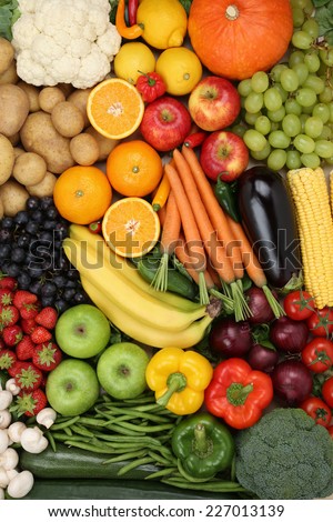 Vegetarian fruits and vegetables like apple, orange and tomato background