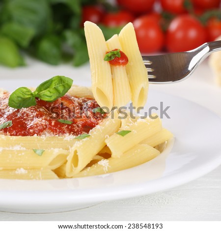 Eating Pasta Rigate with Napoli tomato sauce noodles meal on a plate with fork