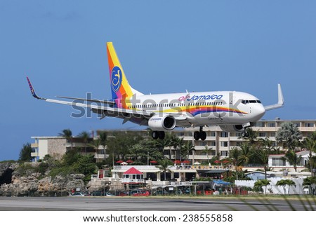 ST. MARTIN, NETHERLANDS ANTILLES - FEBRUARY 8: An Air Jamaica Boeing 737 approaching on February 8, 2014 in St. Martin. St. Martin is rated one of the most dangerous airports in the world.