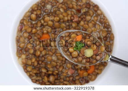 Eating lentil soup stew meal with lentils on spoon from above