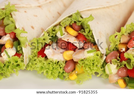 Chicken wrap sandwich filled with beans, lettuce and corn