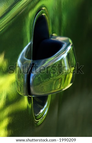 Image shows a car door handle captured in a way that shows the shiny car door surface
