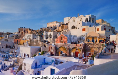 SANTORINI, GREECE-APR 6:Tourists visit the village of Oia on April 6, 2006 in Santorini.The tourism industry is essential for Greece in order for the country to overcome its current financial problems