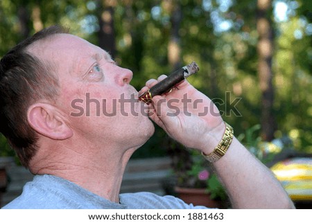 Big Puff - An elderly red-haired man taking a big puff on his cigar