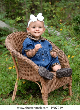 Happy - Happy - Happy - This baby girl is so happy sitting in her wicker chair in the garden.