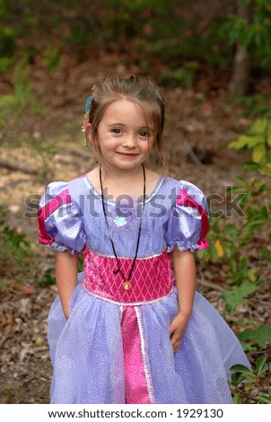 Pretty Princess - A pretty little girl dressed in her princess dress playing outdoors
