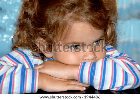 Folded Arms - A girl with big blue eyes and pigtails leaning on her folded arms