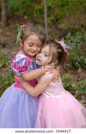 Hugs - Princess Sisters give each other a big hug while playing dress-up outdoors