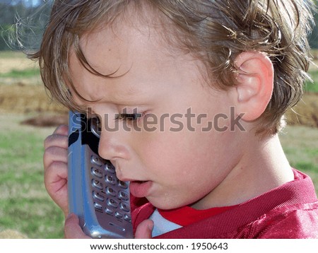 Listening - A young child listening as someone talks to him on the telephone