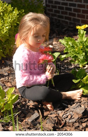 These are Pretty - A little girl admiring the flowers she picked from the garden