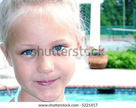 stock-photo--close-up-of-cute-child-with-long-blonde-hair-and-big-baby-blue-eyes-wearing-a-tropical-5221417.jpg