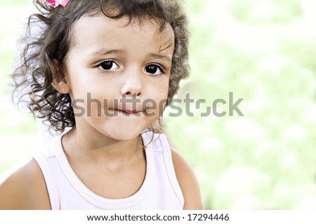 Beautiful little girl with a cute expression on her face.