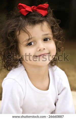 stock photo : Beautiful little brown eyed brunette girl with curly hair and