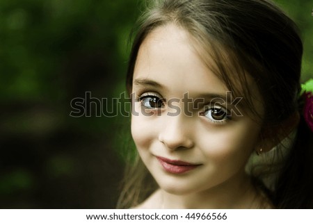 Beautiful brown-eyed brunette girl with a sweet smile