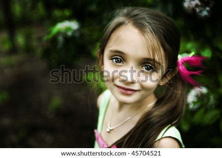 Beautiful brown-eyed brunette little girl with a sweet smile