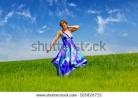 girl standing on the grass in a light blue dress from the fabric