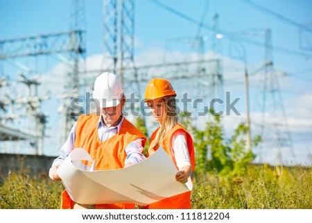 woman and man working as architects on a construction site