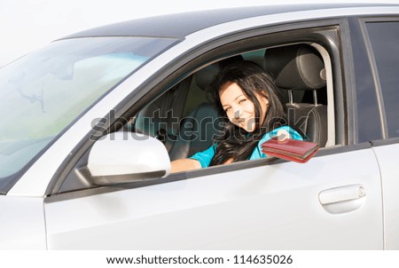 girl in the car gives a driver\'s license