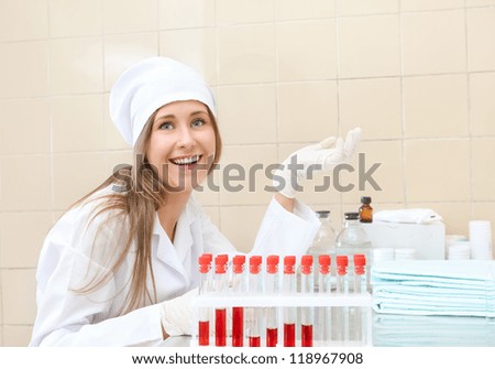 woman in medical gown with tubes of blood