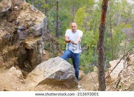 defocused man overcomes dangerous Wake up holding a rope