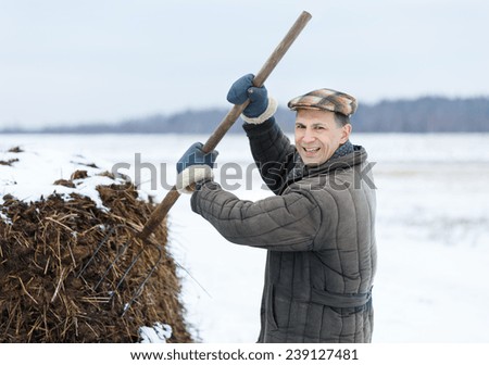 male farmer works with manure in early spring