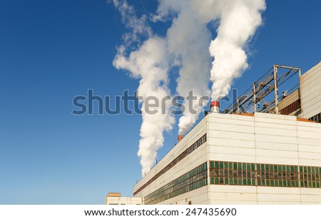 Industrial plant of a furniture factory with smoking chimneys