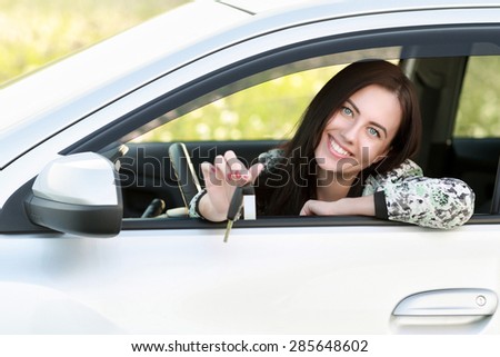 Woman driving showing car keys out the window