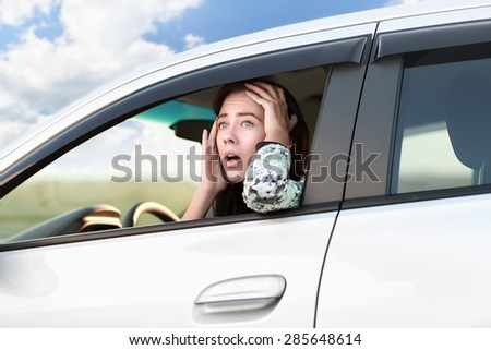 Displeased angry woman driving her car.Negative human expression.