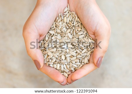 Sunflower seeds\' kernel in woman hands