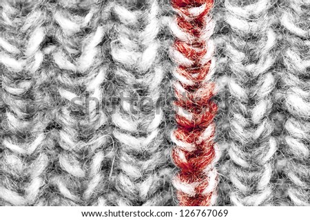 Knitted wool texture, black and white with red line