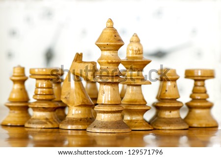 Chess white king with his  suite on chess clock background
